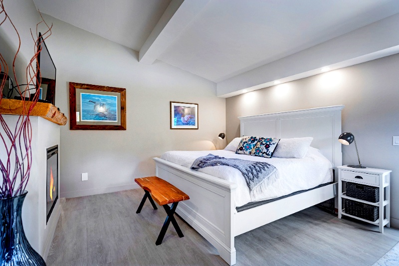 Comfortable queen bed with mountain décor at Rocky Mountain heritage accommodations