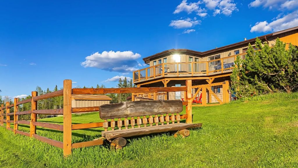 Heritage log cabin lodging at Rocky Mountain View BnB under bright Alberta skies