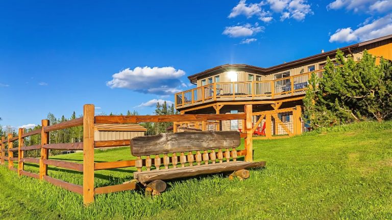 Heritage log cabin lodging at Rocky Mountain View BnB under bright Alberta skies