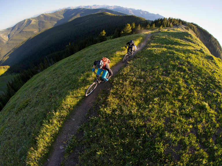 Mountain bikers riding scenic trails along grassy alpine ridges near Rocky Mountain View BnB